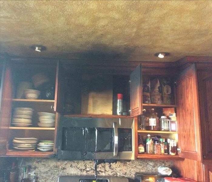 kitchen with burned cabinets